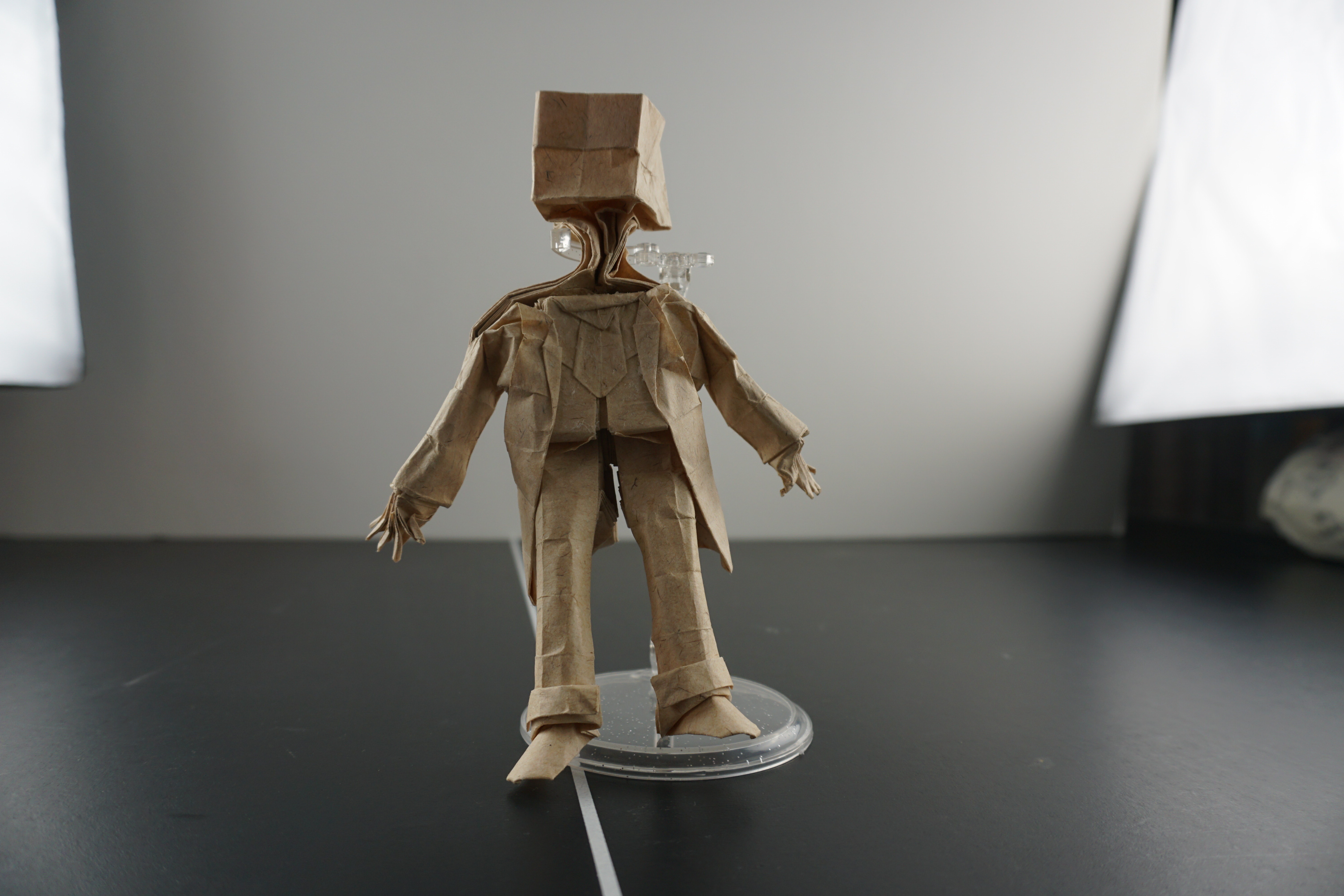 Kraft paper figure with a bag-like square head